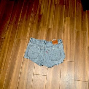 Levi’s 501 jean shorts with button fly + distressed hem. Fit small. Lightly worn